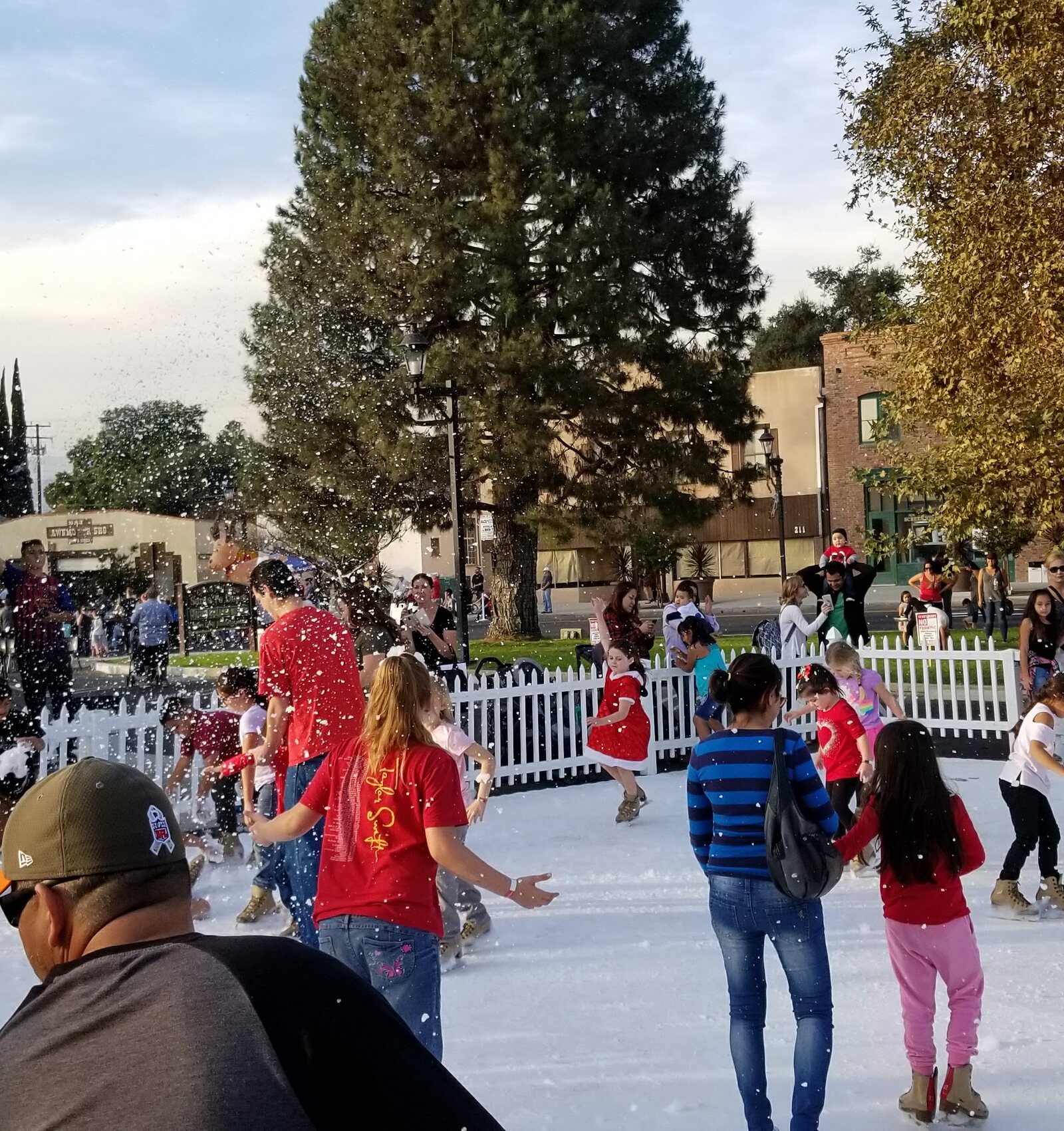 Busy outdoor synthetic ice rink at a Southern California community event