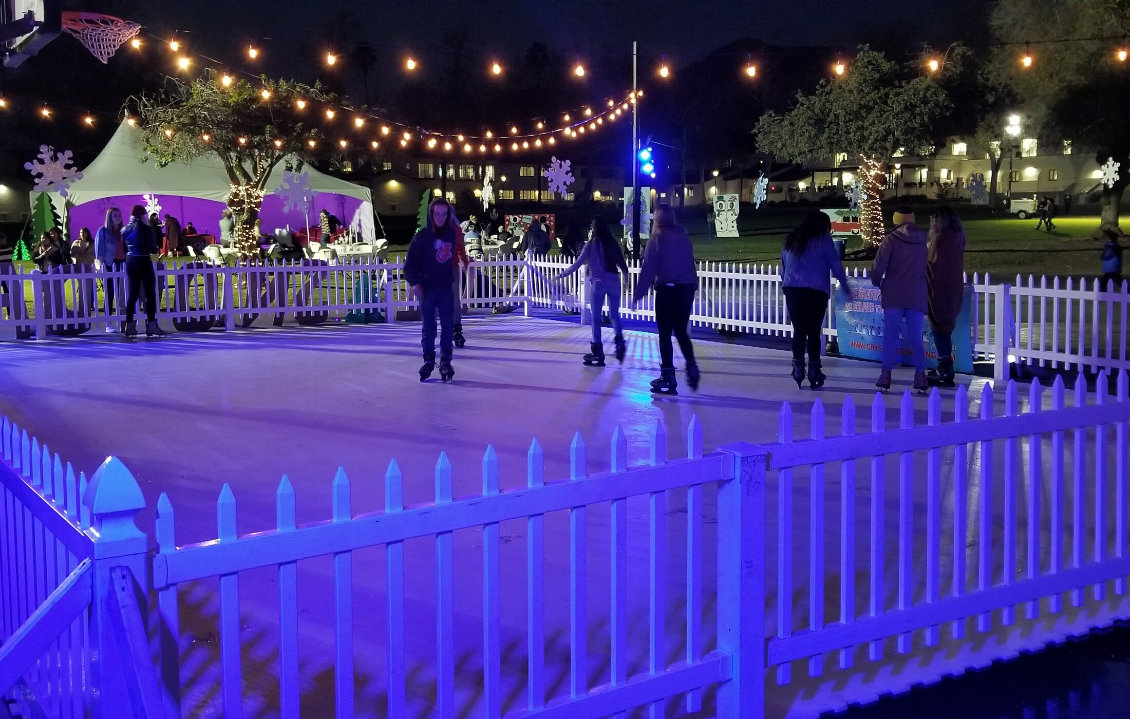 Guests skating on a Crystal Ice Skating rink at a holiday event