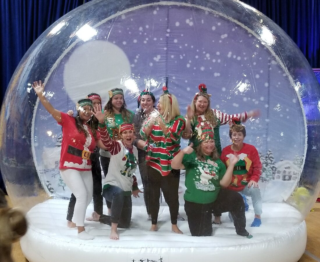 Group posing inside the giant snow globe